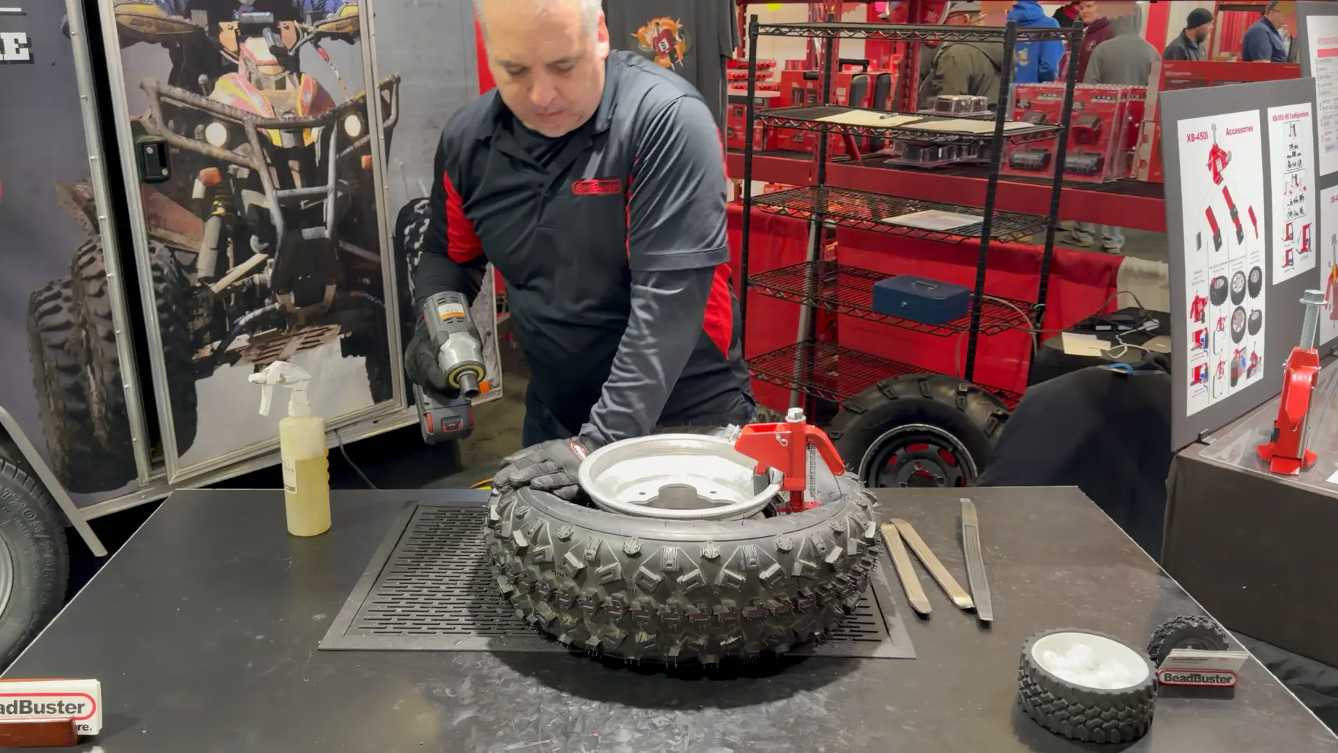 BeadBuster representative demonstrating the XB-550i on an off-road tire with an impact driver